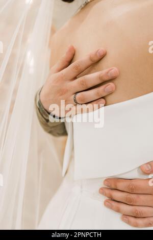groom embraces the bride in a wedding dress Stock Photo