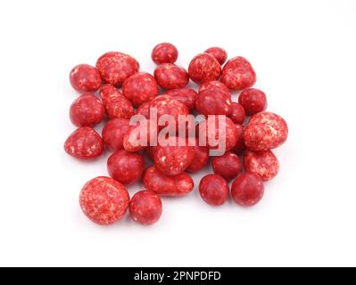 Red candies with icing on a white background. White chocolate with strawberry sweets for tea. Round candies with colored icing. Heap of sugared almond Stock Photo