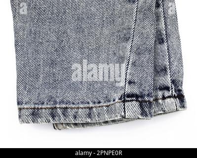 Pants gray jeans on a white background. Bottom of skinny jeans top view. Straight cut jeans, fabric close-up. Stock Photo