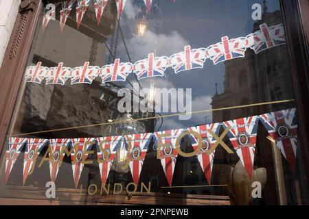 With two weeks before the coronation of King Charles III takes place, union jack bunting is displayed in the window of cigar retail specialist 'James Fox' in St James's, on 19th April 2023, in London, England. King Charles will succeed Queen Elizabeth II on 6th May, who passed away last year. Stock Photo