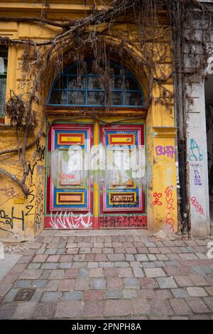 Painted door surrounded by vines, Berlin. Germany. Picture credit garyroberts/worldwidefeatures.com Stock Photo