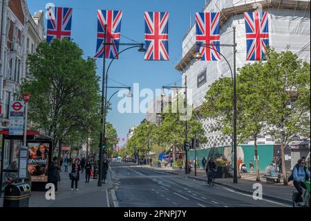 Oxford Street, London, UK. 20th Apr, 2023. Hanging Union flags and banners in blue sky above Oxford Street celebrate the 6th May Coronation of King Charles III. Credit: Malcolm Park/Alamy Live News Stock Photo