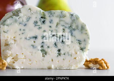 Delicious blue cheese dorblu or gorgonzola with pear and walnuts on white background. Close up. Tasty food Stock Photo