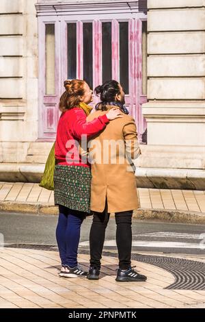 Friendly couple looking up at building, Tours, Indre-et-Loire (37), France. Stock Photo