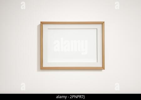 Wooden frame for pictures with rectangular horizontal shape on white wall mockup Stock Photo
