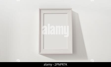 Light wood frame rectangular vertical shape on white wall mockup Stock Photo