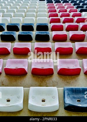 Overhead view of rows of red, white and blue plastic chairs Stock Photo