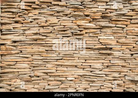 House garden stone wall made of sandstone slabs closeup as stone background Stock Photo