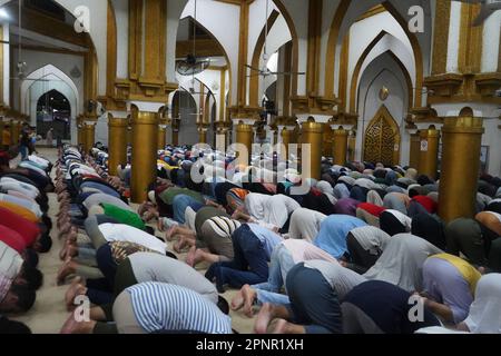 Quiapo, Philippines. 20th April, 2023. Muslims of Quiapo, Manila attends the first night prayer before Eid al-Fitr. There will be no taraweeh prayers on this last night of Ramadan, but a devout Muslim will spend the night in prayer, remembrance of Allah and reading the Quran because this evening is regarded as a very blessed night and Muslims believe that it should be spent in nafl (voluntary) salat (prayers) and worship. (Credit Image: © Sherbien Dacalanio/Alamy Live News) Stock Photo