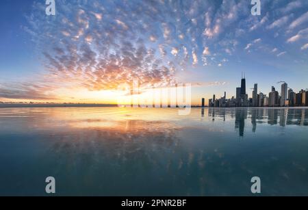 City skyline reflections in Lake Michigan at Sunrise from North Avenue Beach, Chicago, Illinois, USA Stock Photo