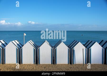 Yport, beach with beach cabins on the blue English Channel Stock Photo