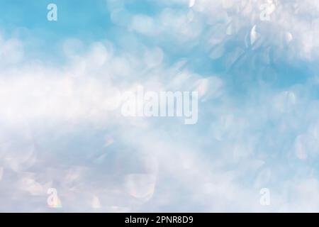 Shiny bokeh blurred winter blue background. Abstract blurred snow lighting on blue background. Stock Photo