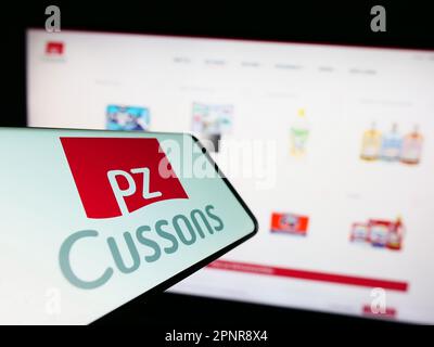 Smartphone with logo of British consumer goods company PZ Cussons plc on screen in front of business website. Focus on center of phone display. Stock Photo