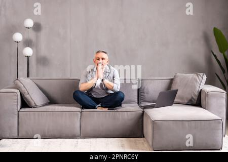 Portrait of thoughtful pondering middle aged hoary man touching chin, looking at camera. Head shot close up pensive mature old grandfather thinking of Stock Photo