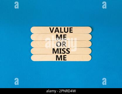 Value or miss me symbol. Concept words Value me or miss me on wooden stick. Beautiful blue table blue background. Business psychological and value or Stock Photo