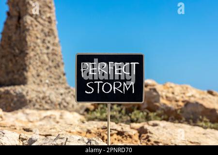 Perfect storm symbol. Concept words Perfect storm on beautiful black chalk blackboard. Beautiful stone blue sky background. Business and Perfect storm Stock Photo