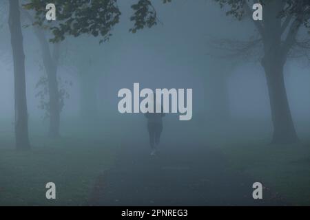 A dense fog wraps a park in Ilford, East London, in the morning. Stock Photo