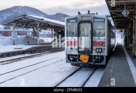 A JR Hokkaido KiHa 54 series train on a winter day at Rumoi Station in Japan. Stock Photo