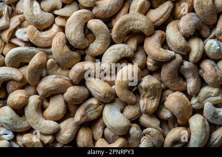Pile cashew nuts without shell, close up, top view. Whole nut kernels Stock Photo