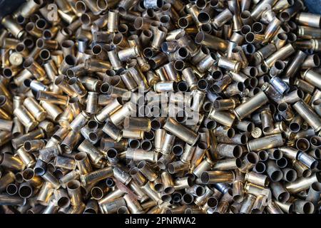 Pile of used pistol cartridges, close up. Bunch of empty pistol shells as a background Stock Photo