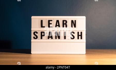 Learning language concept. Learning Spanish word on white letter board. Foreign language course concept. Stock Photo