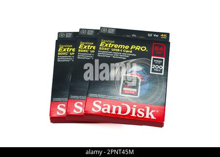 Irvine, Scotland, UK-March 18, 2023: Three SanDisk branded Extreme Pro SDXC UHS-1 64gb Card with graphics icons and general information relevant to th Stock Photo