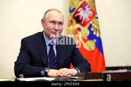 Novo-Ogaryovo, Russia. 20th Apr, 2023. Russian President Vladimir Putin smiles after appointing Mikhail Kotyukov as governor for the Krasnoyarsk Territory during a video conference call from the official residence at Novo-Ogaryovo, April 20, 2023 outside Moscow, Russia. Credit: Gavriil Grigorov/Kremlin Pool/Alamy Live News Stock Photo