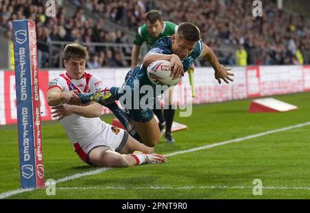 Warrington Wolves' Matty Russell goes over for a try past St Helens Saints' Jon Bennison, during the Betfred Super League match at the Totally Wicked Stadium, St Helens. Picture date: Thursday April 20, 2023. Stock Photo