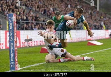 Warrington Wolves' Matty Russell goes over for a try past St Helens Saints' Jon Bennison, during the Betfred Super League match at the Totally Wicked Stadium, St Helens. Picture date: Thursday April 20, 2023. Stock Photo