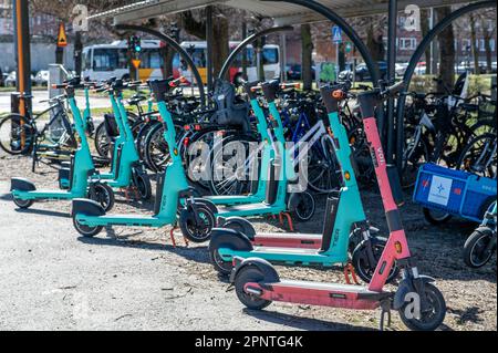 Electric scooters parked outisde the railway station in Norrkoping, Sweden. These vehicles are controversial and recently Paris voted for a ban. Stock Photo