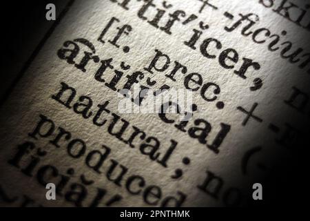 Definition of word artificial on dictionary page, close-up Stock Photo
