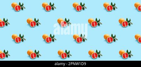 Many ripe grapefruits on light blue background. Pattern for design Stock Photo