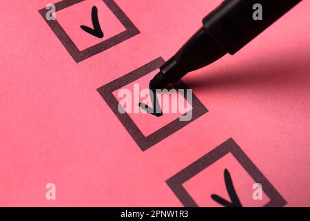 Black pen marking on checklist box, closeup Stock Photo
