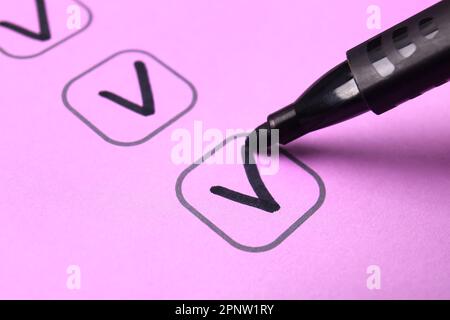 Black pen marking on checklist box, closeup Stock Photo