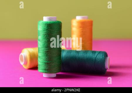 Set of different sewing threads on color table Stock Photo