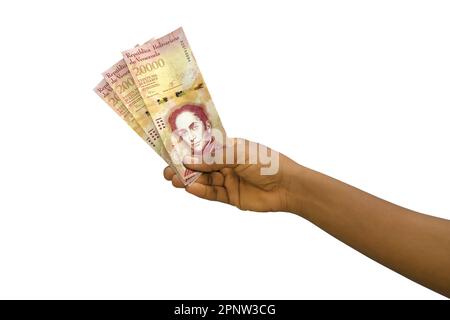 Fair hand holding 3D rendered Venezuelan bolivar notes isolated on white background Stock Photo