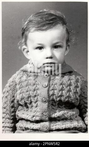 BRNO, THE CZECHOSLOVAK REPUBLIC, CIRCA 1972: A small boy retro photo. Portrait photo was taken in photo studio. Early seventies. Photo with dark tint, Stock Photo