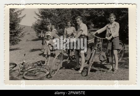 THE CZECHOSLOVAK REPUBLIC, CIRCA 1930: Vintage photo of a family on the trip. Young cyclists. A group of young people on a bike trip. Stock Photo