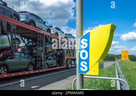Itatiba-sp,brazil-April 19,2023 Telephone on highway used for emergencies with the universal signal of s.o.s and a truck with cars passing on the high Stock Photo