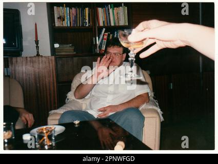 Retro photo shows man refuse the glass of wine at the table. Stock Photo