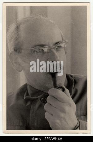 Vintage photo shows man with pipe. Stock Photo