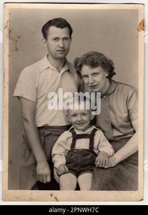 A vintage photo shows mother, father and their small son. Stock Photo
