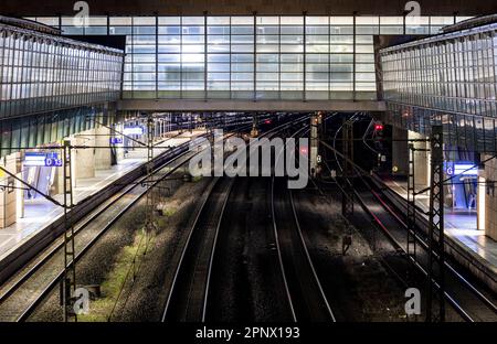 Laatzen, Germany. 21st Apr, 2023. Tracks run up in the early morning darkness through the Laatzen fairground station in the Hanover region. With nationwide warning strikes, the rail and transport union EVG paralyzed parts of public transport on Friday. Credit: Moritz Frankenberg/dpa/Alamy Live News Stock Photo