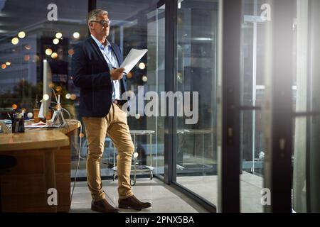 Working quietly and let success be your noise. a dedicated businessman working alone in his office after hours. Stock Photo