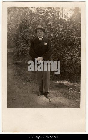 Vintage photo shows young man poses in the city park. Stock Photo