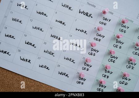 4 day work week printed calendar with pink pins on three days off in week weekend days four day working week concept. Modern approach doing business short workweek. Effectiveness of employees. Productivity and efficiency days off  Stock Photo