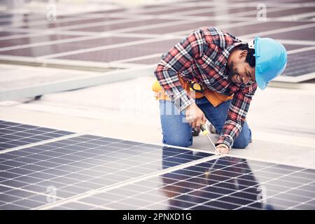 Solar panel, repair and engineering man on rooftop with tools, energy saving and sustainable power maintenance. African person, electrician contractor Stock Photo