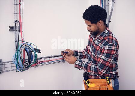 Technician, black man and electrician checking cables, fixing faulty wires and server mechanic. Male employee, entrepreneur and engineer with tools Stock Photo