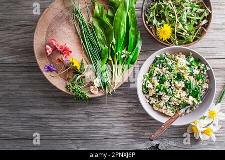 Fresh risotto with spring plants and herbs. Healthy spring food concept Stock Photo