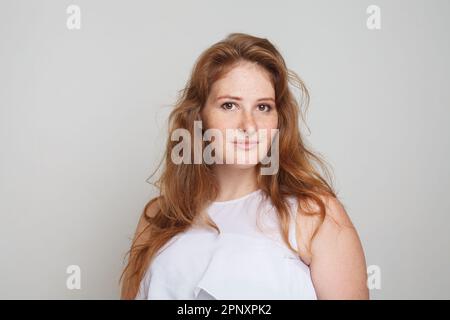 Perfect young redhead woman with wavy hairstyle portrait Stock Photo
